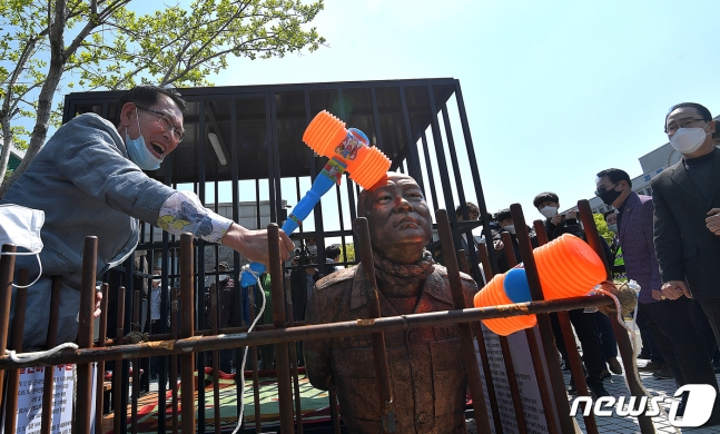 全斗焕@韩国前总统全斗焕跪像被立在法院前，大妈上去就是一巴掌