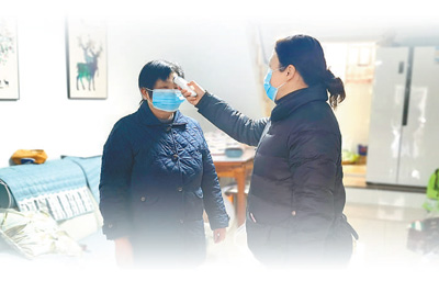 刘珍(右)在社区走访,为居民测量体温。 刘珍(右)在社区走访,为居民测量体温。