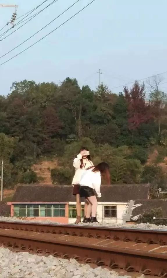环球时报@两网红为涨粉在铁轨上拍视频 险遭火车撞